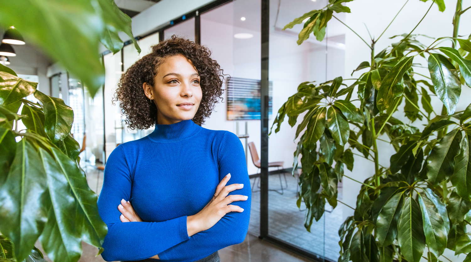 Professional woman in modern office with plants background - creative workspace